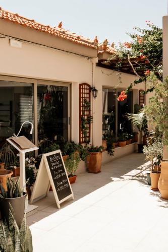 a shop with a chalkboard sign in front of a store at Irida Hotel Agia Pelagia in Agia Pelagia
