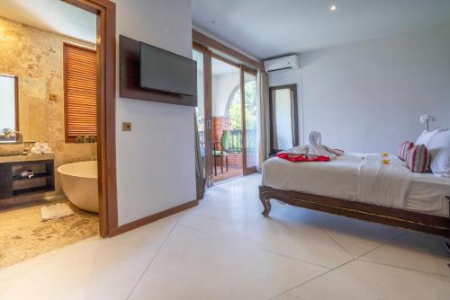 Ένα ή περισσότερα κρεβάτια σε δωμάτιο στο Menzel Ubud