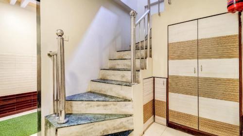 a staircase in a house with a glass door at Hotel Raj Inn in Navi Mumbai