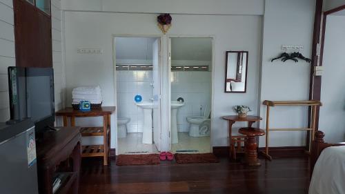 a bathroom with a sink and a toilet in a room at Khao Kho Flora in Khao Kho