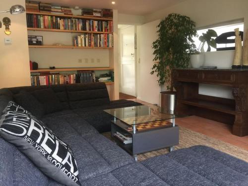 a living room with a couch and a piano at Near Amsterdam, The Hague, Leiden and North Sea in Warmond