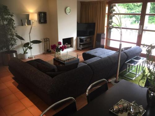 a living room with a couch and a tv at Near Amsterdam, The Hague, Leiden and North Sea in Warmond