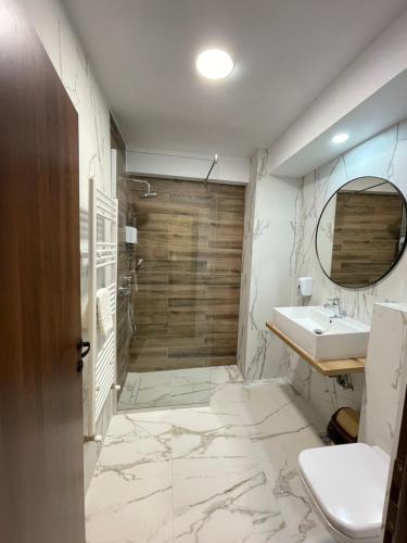 a bathroom with a sink and a shower at Hotel City in Tulcea