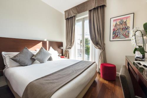 a hotel room with a bed and a window at Hotel Milano Scala in Milan