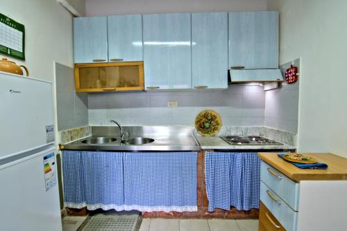 a kitchen with a sink and a refrigerator at Villa Very in Marina di Campo