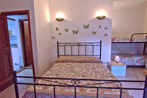 a bedroom with a bed and two bunk beds at Villa Very in Marina di Campo