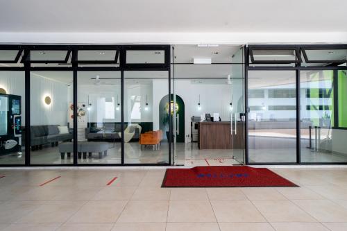 a living room with glass doors and a red rug at Geo38 Premier Suites Genting Highlands in Genting Highlands
