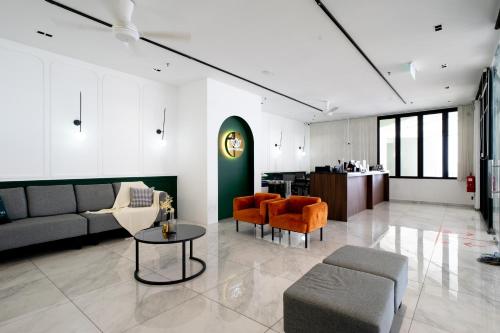 a living room with a couch and chairs and a table at Geo38 Premier Suites Genting Highlands in Genting Highlands