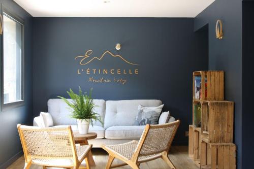 a living room with a couch and a table and chairs at L'Etincelle Mountain Lodge in Chamrousse