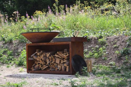 a wooden box full of wood with a bowl on top at L'Etincelle Mountain Lodge in Chamrousse
