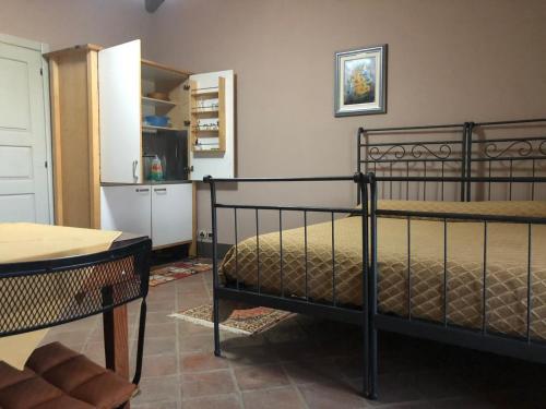 a bedroom with a bed and a table and a kitchen at Agriturismo la Longa in Poirino