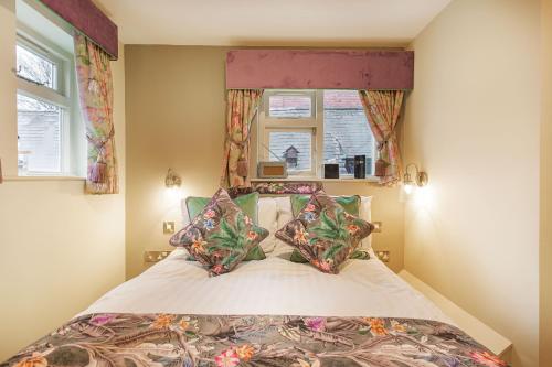 a bedroom with a bed and a window at The Wynnstay Hotel, Oswestry, Shropshire - The Coaching Inn Group in Oswestry
