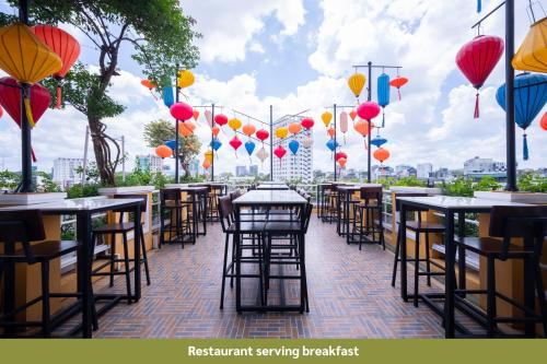 a row of tables and chairs on a patio with balloons at Duc Vuong Saigon Hotel - Bui Vien in Ho Chi Minh City