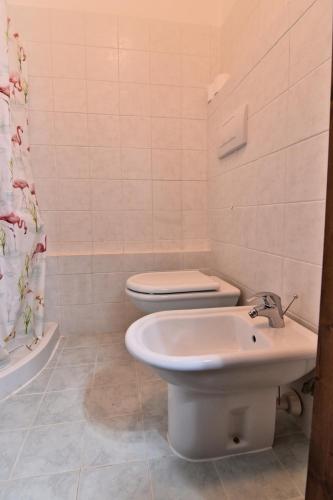 a bathroom with a toilet and a sink at Villa Very in Marina di Campo