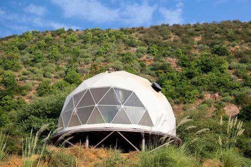 a dome tent in the middle of a hill at Teela- The Glamping Resort, Jaipur in Udāsar