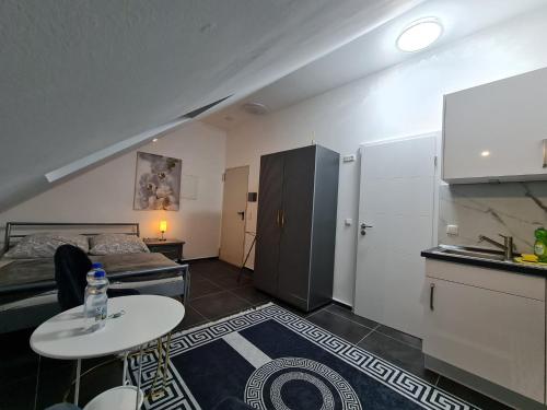 a small room with a bed and a table at Roggendorf Zimmervermietung in Roggendorf