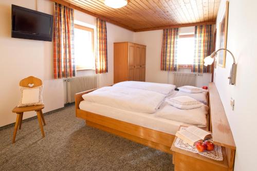 a bedroom with a bed and a table with fruit on it at Lienharterhof in Monguelfo