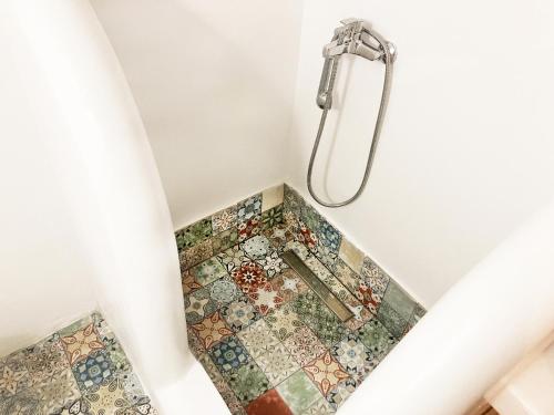 a bathroom with a shower with a mosaic floor at Private Beach House Greece in Saterlí