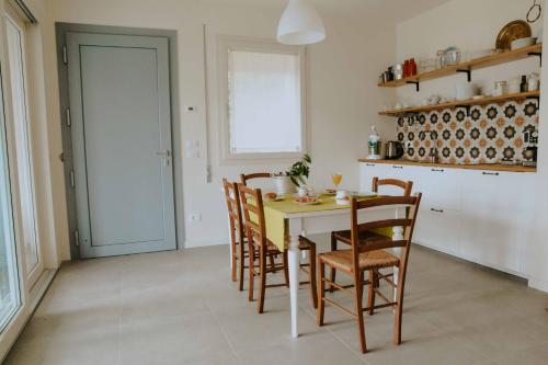 a kitchen with a table and chairs in a room at Casalloro in Valdagno