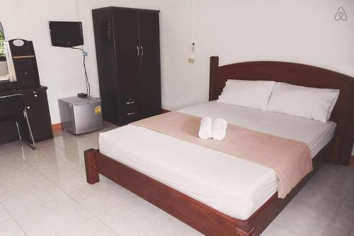 a bedroom with a bed with two towels on it at Thai Muang Resort in Thai Muang