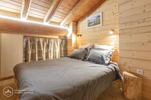 阿尔克河畔博讷瓦勒Chalet Le Bois Joli的小木屋里有一张床的卧室