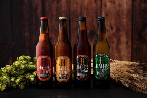 a group of bottles of beer sitting next to a bunch of grapes at Guesthouse Haler in Podčetrtek