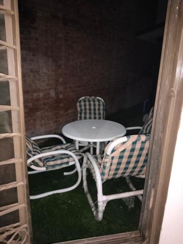 two chairs and a table and a table and chairs at 1 Kanal Entire House with 4 Bedrooms in Lahore