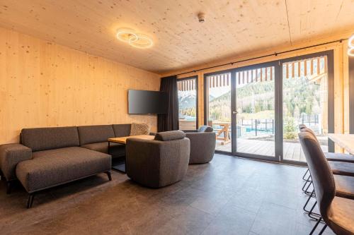 a living room with a couch and chairs and a table at Alpenchalets Biberwier Zugspitze by ALPS RESORTS in Biberwier