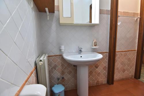 a bathroom with a sink and a toilet at Villa Very in Marina di Campo