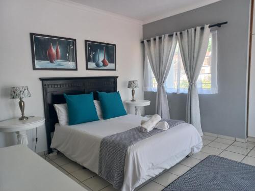a bedroom with two beds and a window at Bougainvillea BNB in Durban