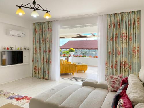 a living room with a couch and a television at Boutique Citadel in Eforie Nord