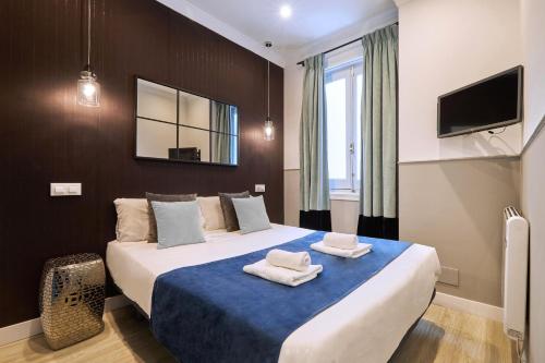 a bedroom with a large bed with towels on it at Jorge Juan Excellent, by Presidence Rentals in Madrid