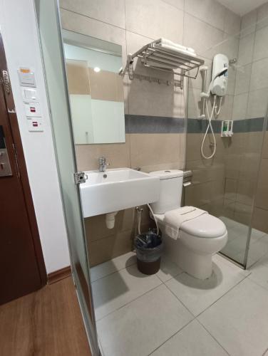 a bathroom with a sink and a toilet and a mirror at Greencity Hotel in Sungai Petani