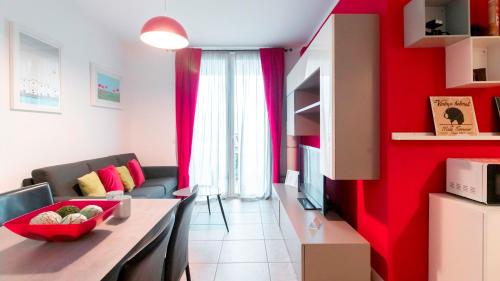 a living room with a red accent wall at Branda Castiglioni 2 in Milan