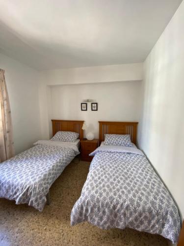 two beds in a small room with at Calpe Mar y Playa in Calpe