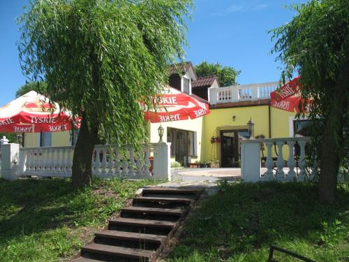 a building with red and white umbrellas and stairs at Zacisze in Ulan