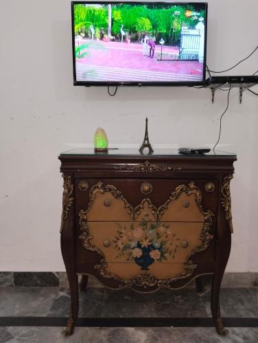 a tv sitting on top of a dresser in a room at 1 Kanal Entire House with 4 Bedrooms in Lahore