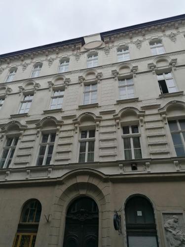 a large building with many windows on a street at Erkel Rooftop Suites in Budapest