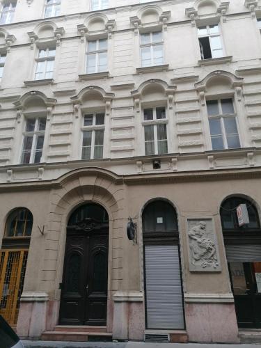 a building with black doors and windows on a street at Erkel Rooftop Suites in Budapest