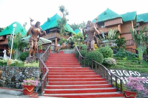 a flight of red stairs with statues of men at La Virginia Leisure Park and Amusement in Mataasnakahoy