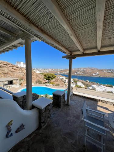 a view from the patio of a villa with a swimming pool at Yalos Mykonos Ornos Pouli private apartments w shared swimming pool in Mýkonos City