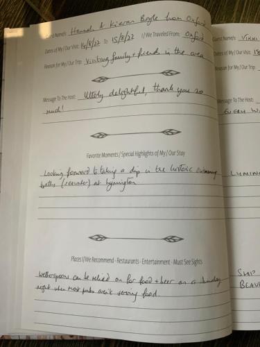 an open book with handwriting on the pages at THE KNIGHTWOOD OAK a Luxury King Size Bed - En-Suite Space - LYMINGTON NEW FOREST with Totally Private Entrance - Key Box entry - Free Parking & Private Outdoor Seating Area - Town ,Shops , Pubs & Solent Way Walking Distance & Complimentary Breakfast in Lymington