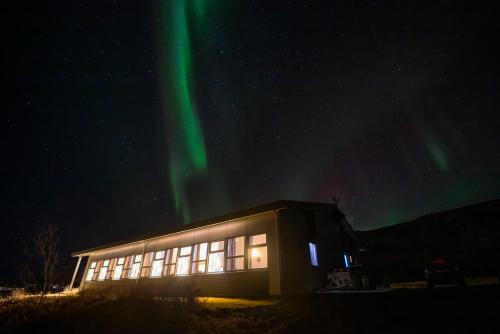 a building with the aurora in the sky at Hotel Kvika in Ölfus