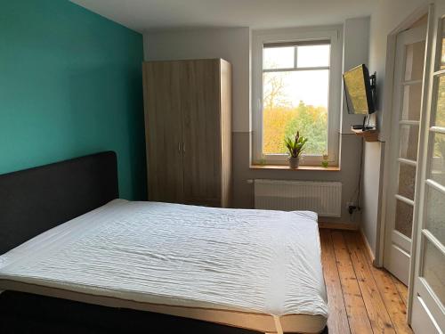 a bedroom with a bed in a room with a window at Ferienwohnung Hamburg - Kirchwerder in Hamburg