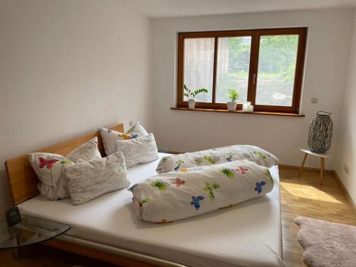 a bed with pillows on it in a room at Familienfreundliche FeWo in Offenburg