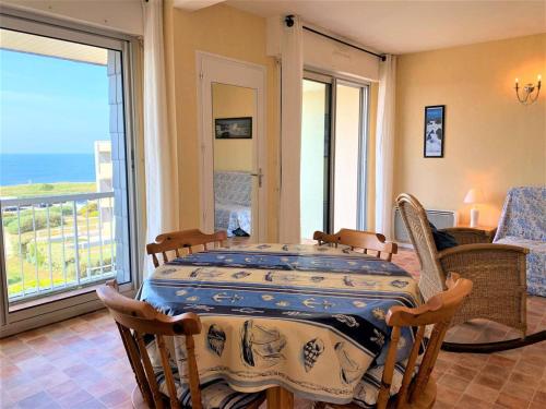 une salle à manger avec une table et une vue sur l'océan dans l'établissement Quiberon - Appartement 2 pièces avec balcon, parking et animaux acceptés - FR-1-478-74, à Quiberon