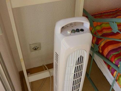 une pièce avec un radiateur à côté d'un lit superposé dans l'établissement Charmant T2 cabine rénové avec piscine, parking privé, proche plage et commerces - FR-1-607-91, au Cap d'Agde