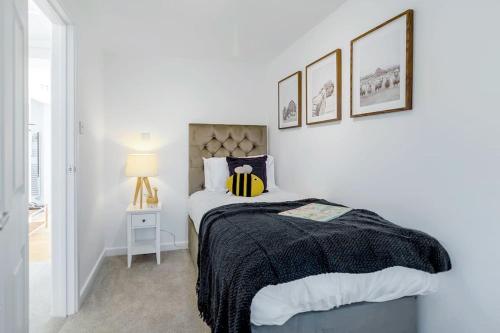 a bedroom with a bed with a black and white blanket at Fen Lane Retreat in Norwich