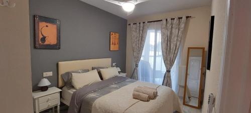 a bedroom with a bed and a window at Hernando Sea Front Optic Fiber Internet Apartment in Calpe