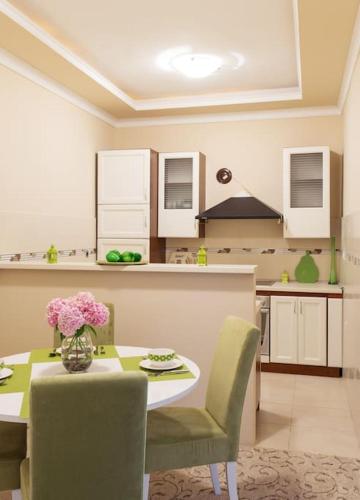 a kitchen with a table with a vase of flowers on it at Summer retreat in Kotor